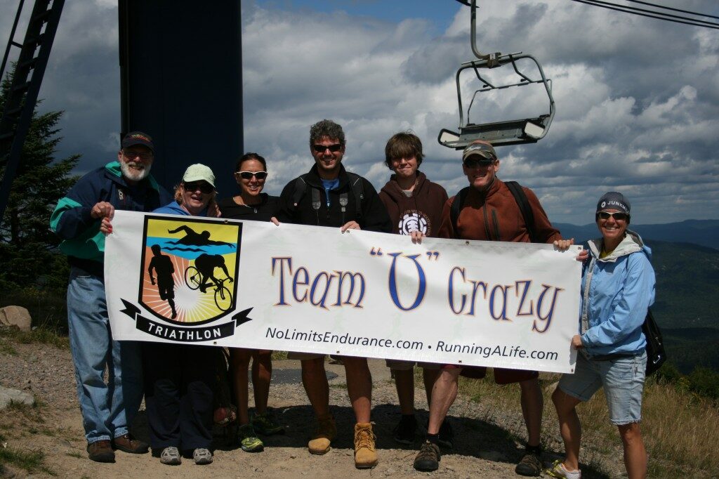 A group of people standing in front of a ski lift.