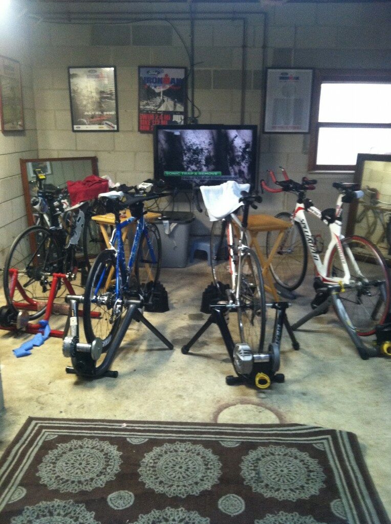 A group of bicycles in a garage with a tv.