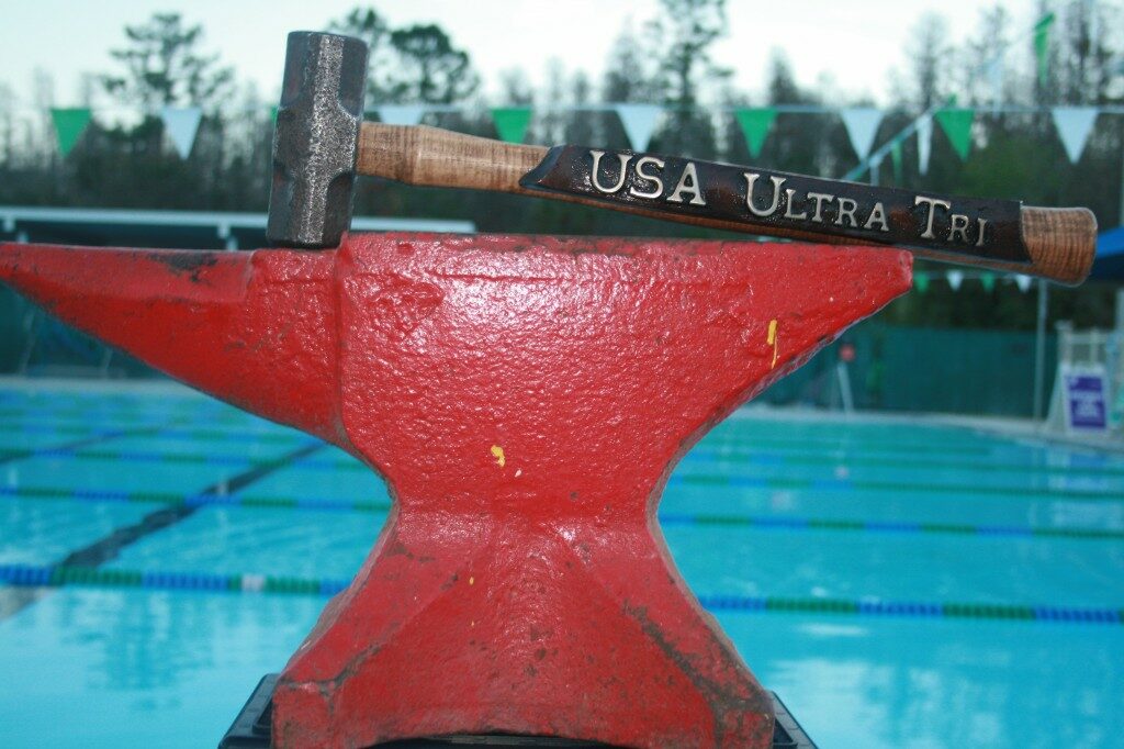 A red hammer sits on top of a pool.