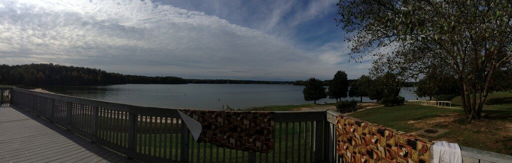 A view of a lake from the deck of a house.
