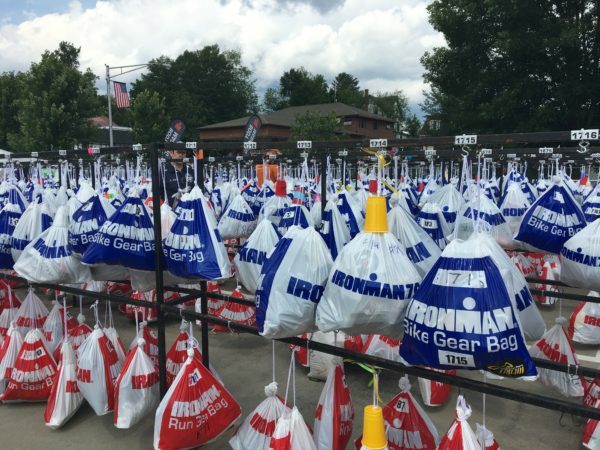 A group of people with bags in front of them.