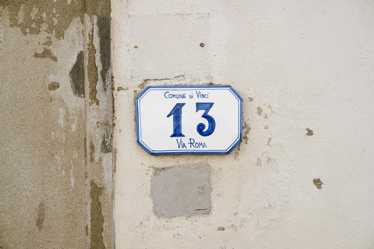 A blue and white sign on a wall.