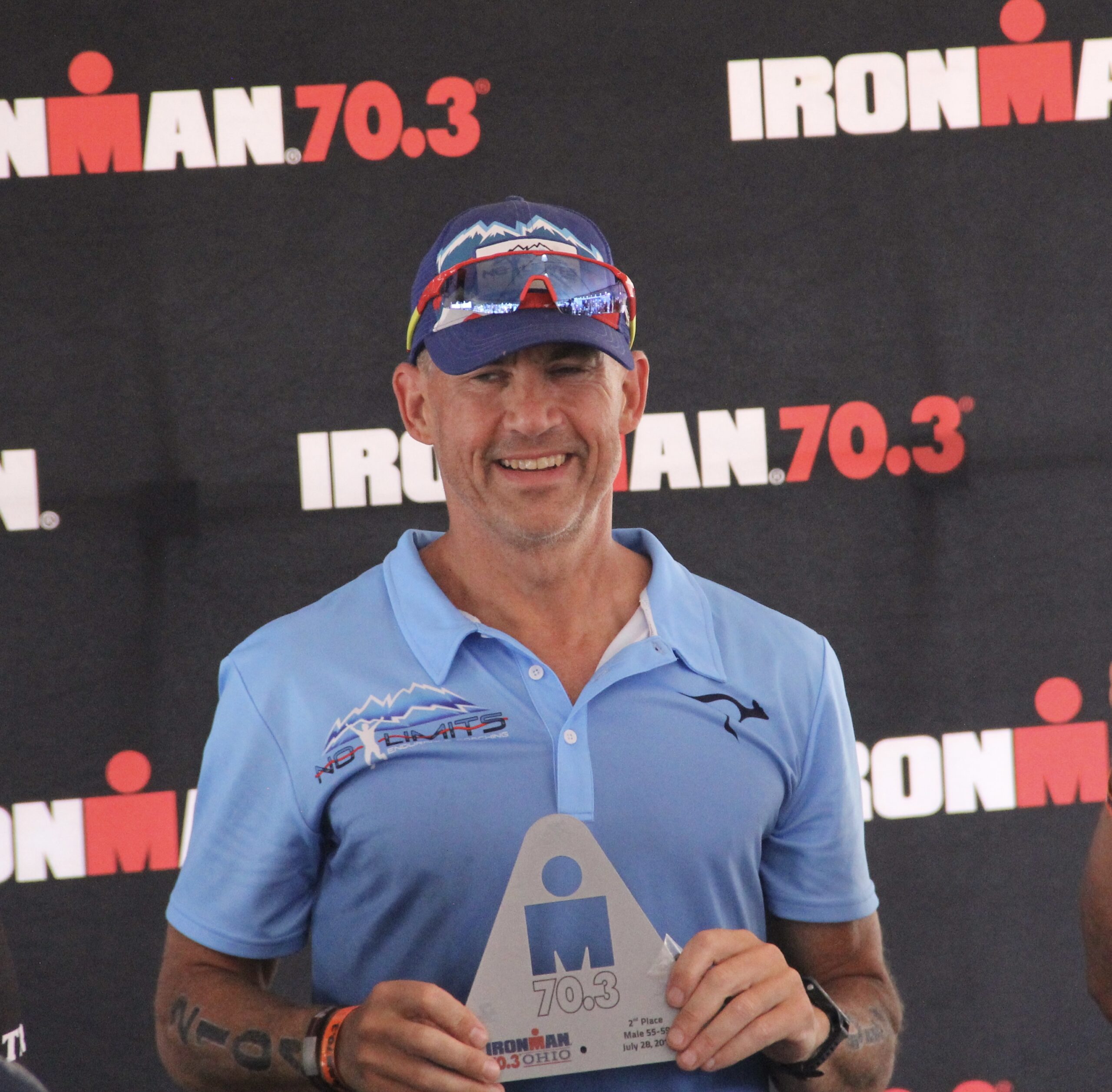 Image of Coach John DiPalo with Ironman Ohio 70.3 trophy. 