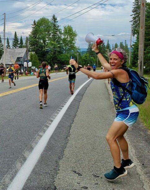 Coach Maria cheering for her athletes on course. 