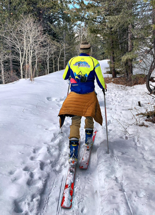 A person is skiing down a snowy trail.