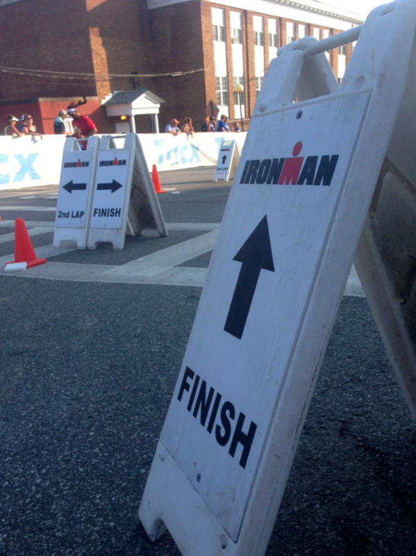 A sign with arrows pointing to the finish line.