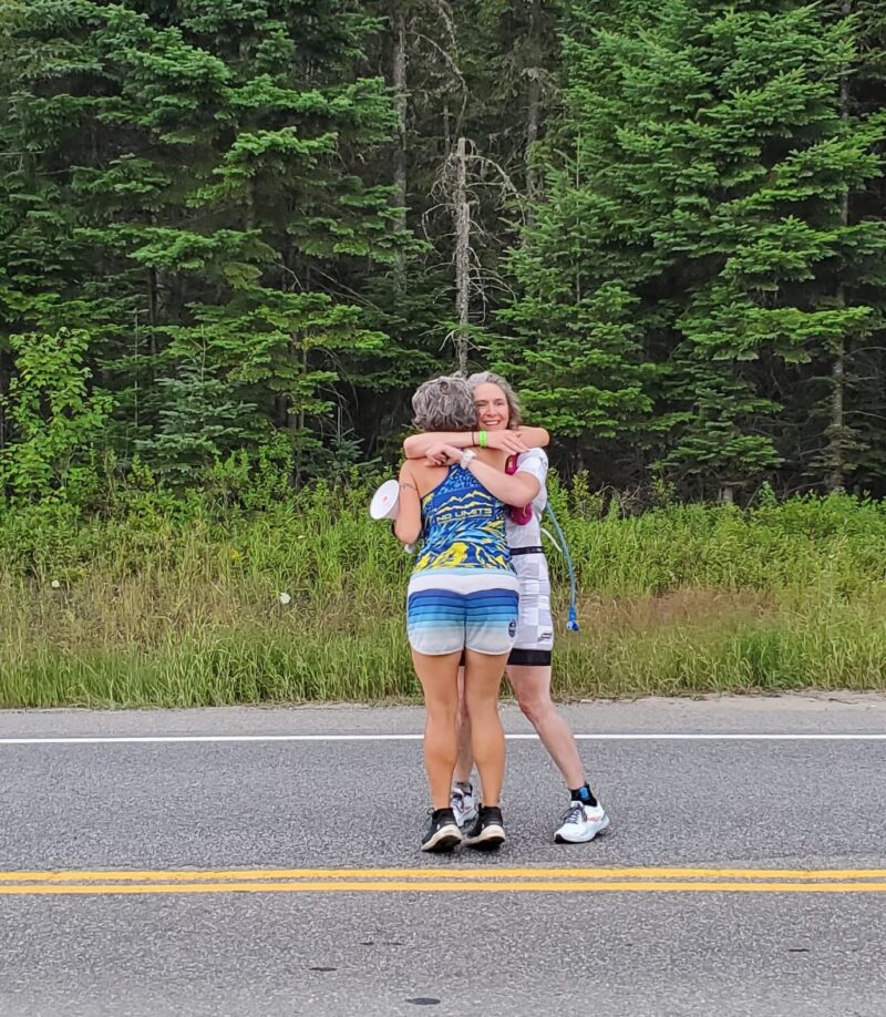 Coach and athlete hugging